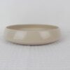 Sandstone beige speckled stoneware shallow bowl with wide opening, rounded sides and glossy finish