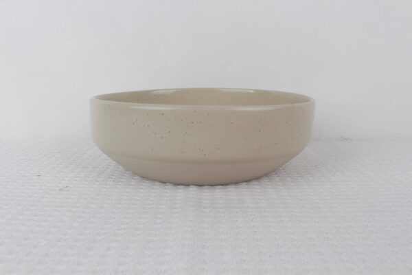 Sandstone beige speckled stoneware serving bowl with deep rounded shape and minimalist design