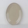 Sandstone oval stoneware serving platter with glossy beige speckled glaze and gently raised rim