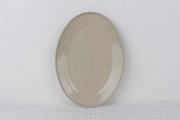 Sandstone oval stoneware serving platter with glossy beige speckled glaze and gently raised rim